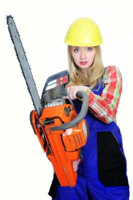 Woman holding a chainsaw